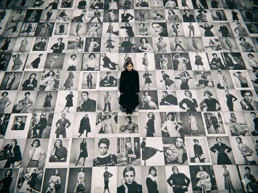 Model Standing on a Floor Covered in Black and White Billboards